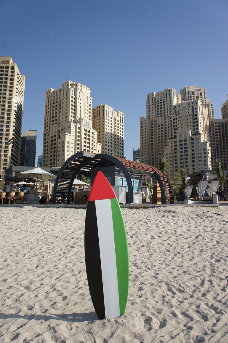 Surfing board with UAE flag on Dubai beach