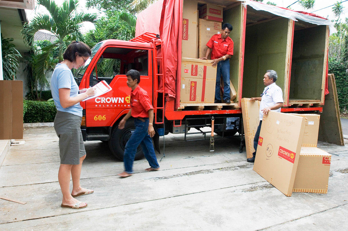 Crew loading household goods on to moving vehicles